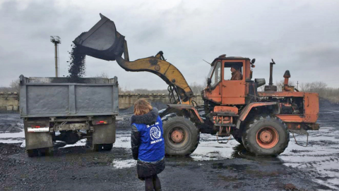 A truck is loaded with coal for vulnerable families