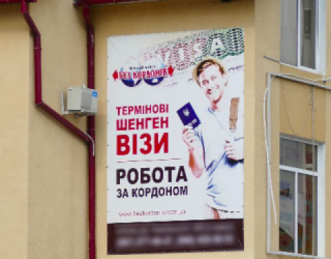 Advertisement of an intermediary for employment abroad in a central street of Kosiv, western Ukraine