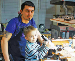 Vitalii with his son in his jewellery enterprise